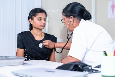 Photo of doctor listening to a patient's heartbeat with a stethoscope
