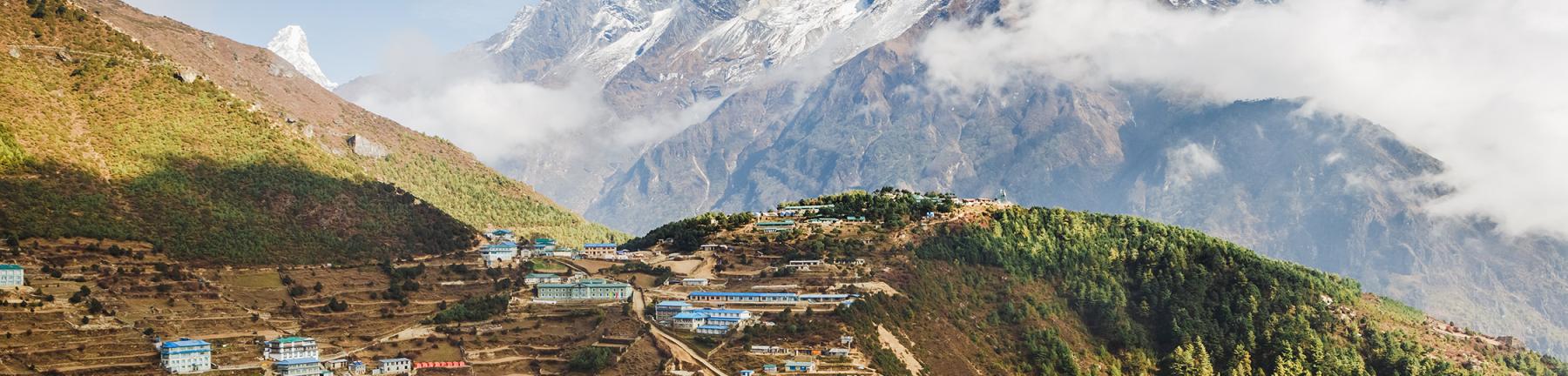 Image of Himalayan village with a snaow capped mountain in the background